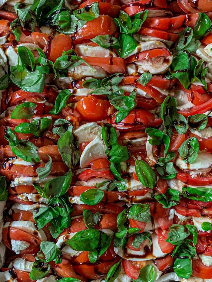 pexels photo 2787672 Mouthwatering Caprese salad with ripe tomatoes, basil, mozzarella, and balsamic glaze.
