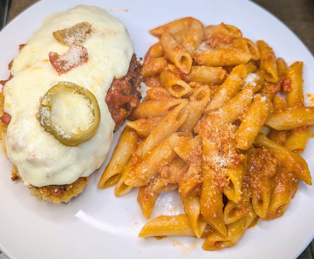 Chicken vodka parm with creamy penne, fresh mozzarella, and cherry peppers