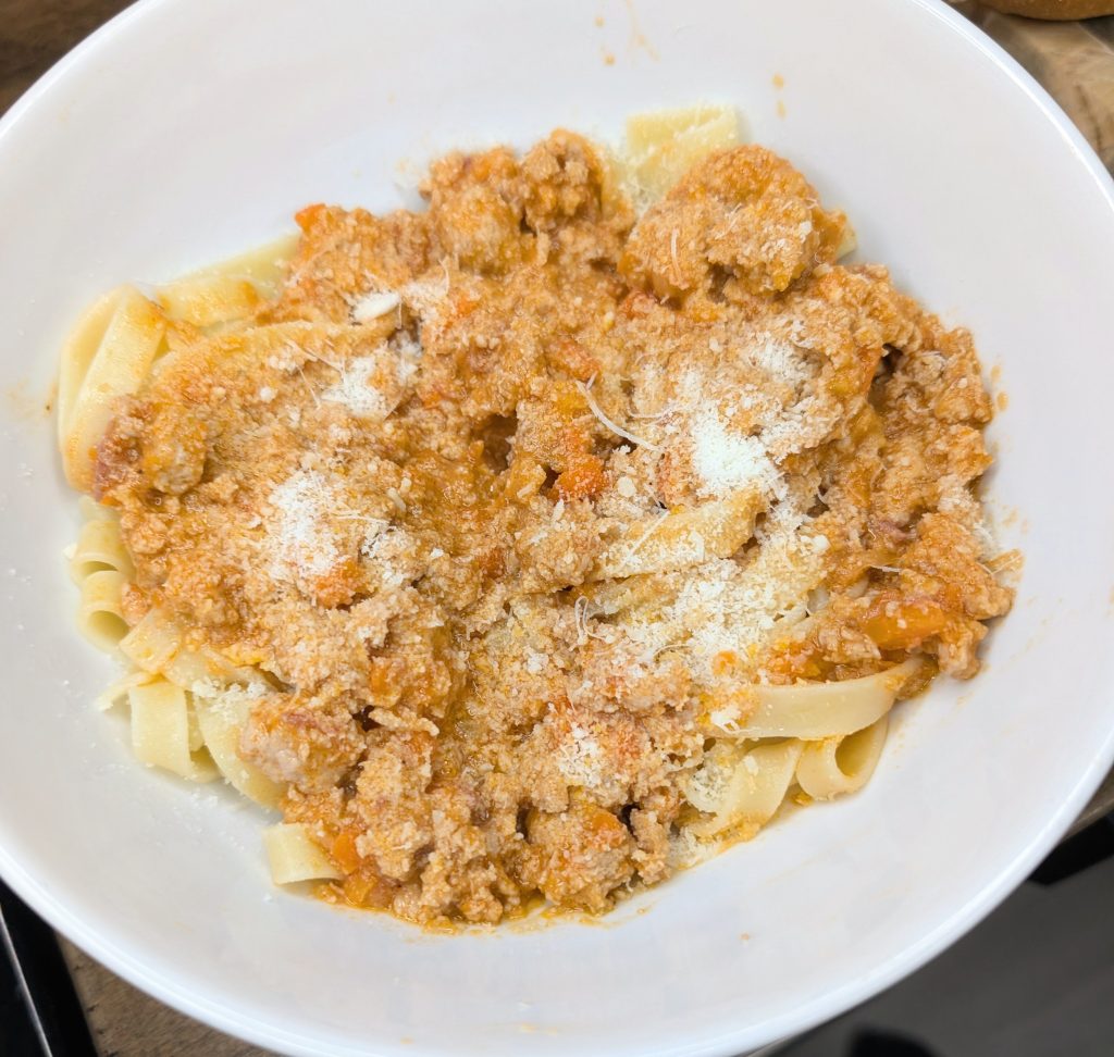 Classic milk-braised Bolognese with pancetta served over fresh tagliatelle and finished with Parmigiano Reggiano