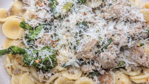 Orecchiette pasta with Italian sausage and broccoli rabe topped with grated pecorino cheese