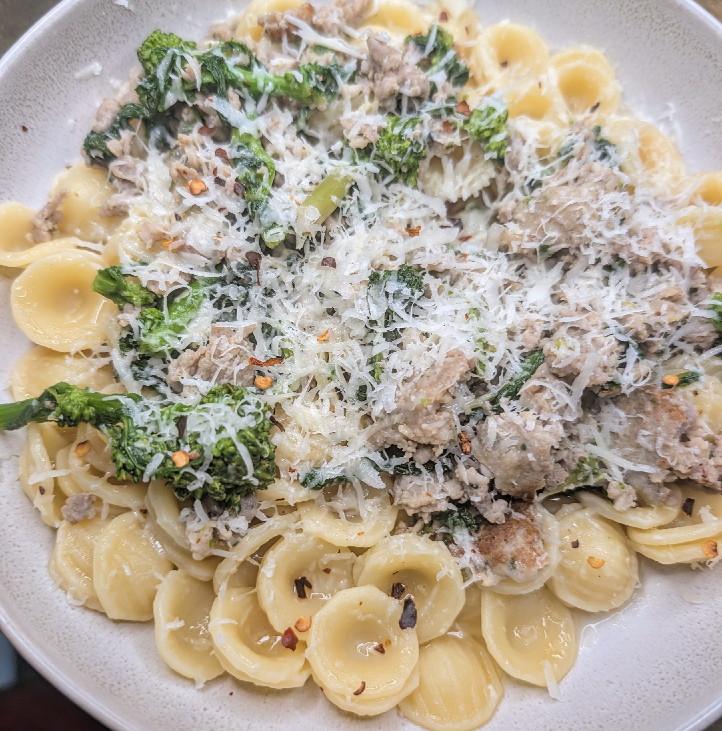 Orecchiette pasta with Italian sausage and broccoli rabe topped with grated pecorino cheese