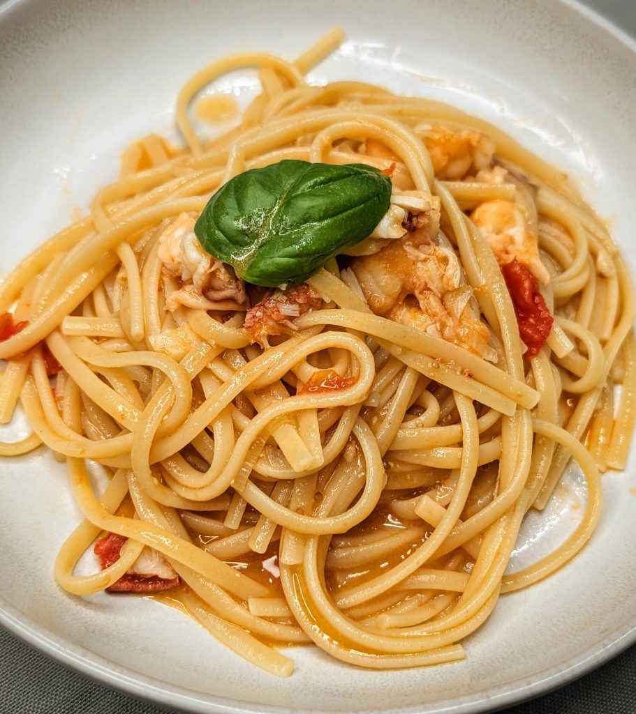 Linguine all'astice lobster pasta with cherry tomatoes and fresh basil