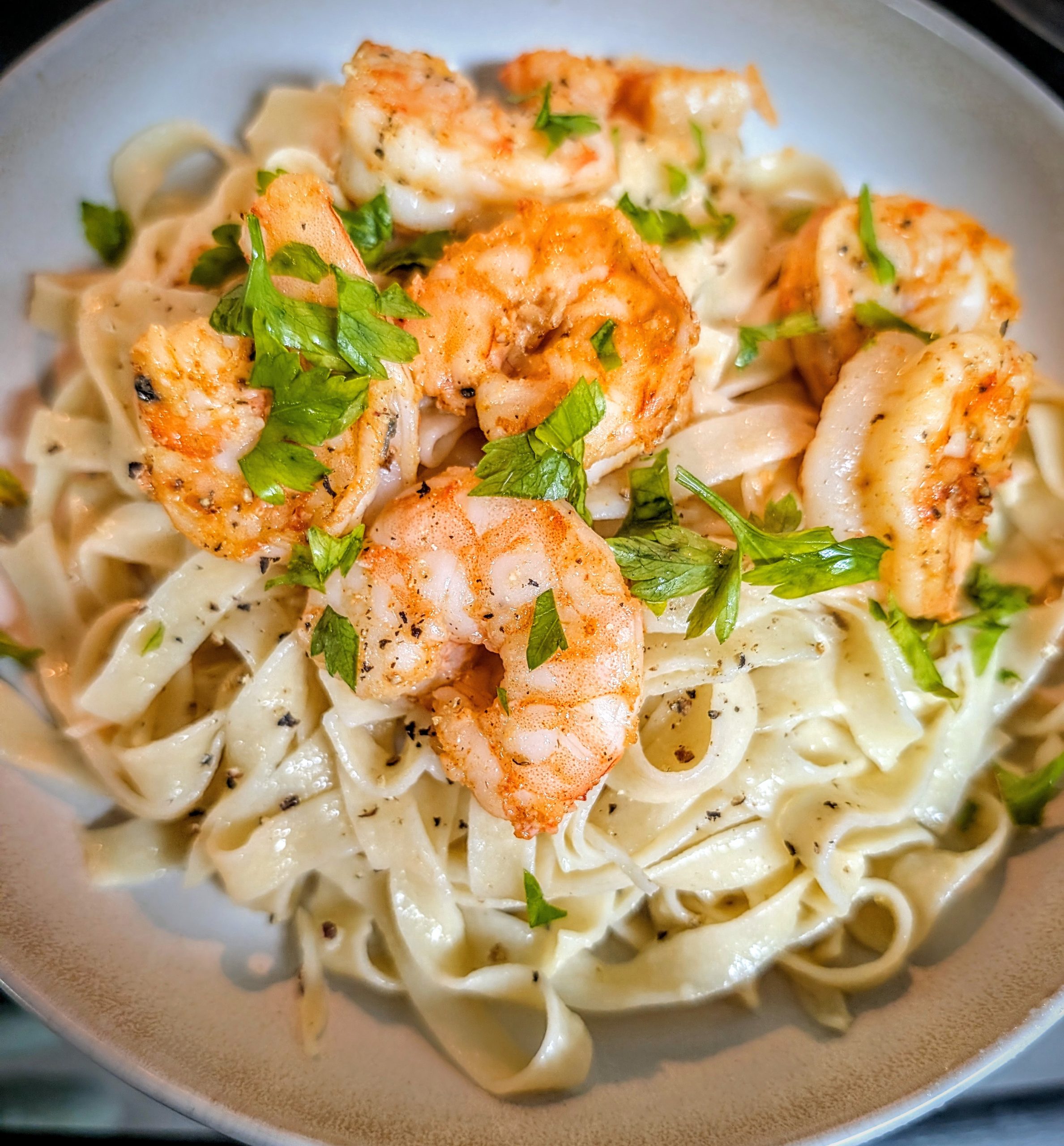 Garlic shrimp fettuccine Alfredo made with butter, Parmigiano Reggiano, and fresh parsley